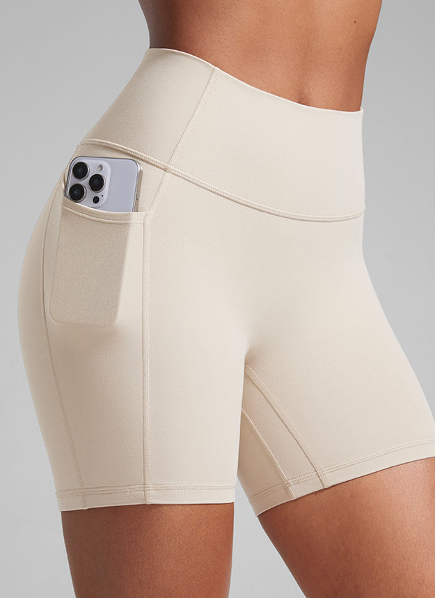 CRZ YOGA Butterlift Womens Scrunch Butt No Front Seam Pocket Biker Shorts 5'' Mojave Tan @model_info:Crystal